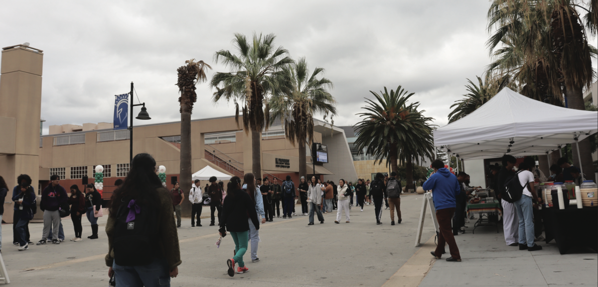 Students socialize and walk across 7th Street Plaza outside of the Provident Credit Union Event Center while student organizations and clubs table on campus.